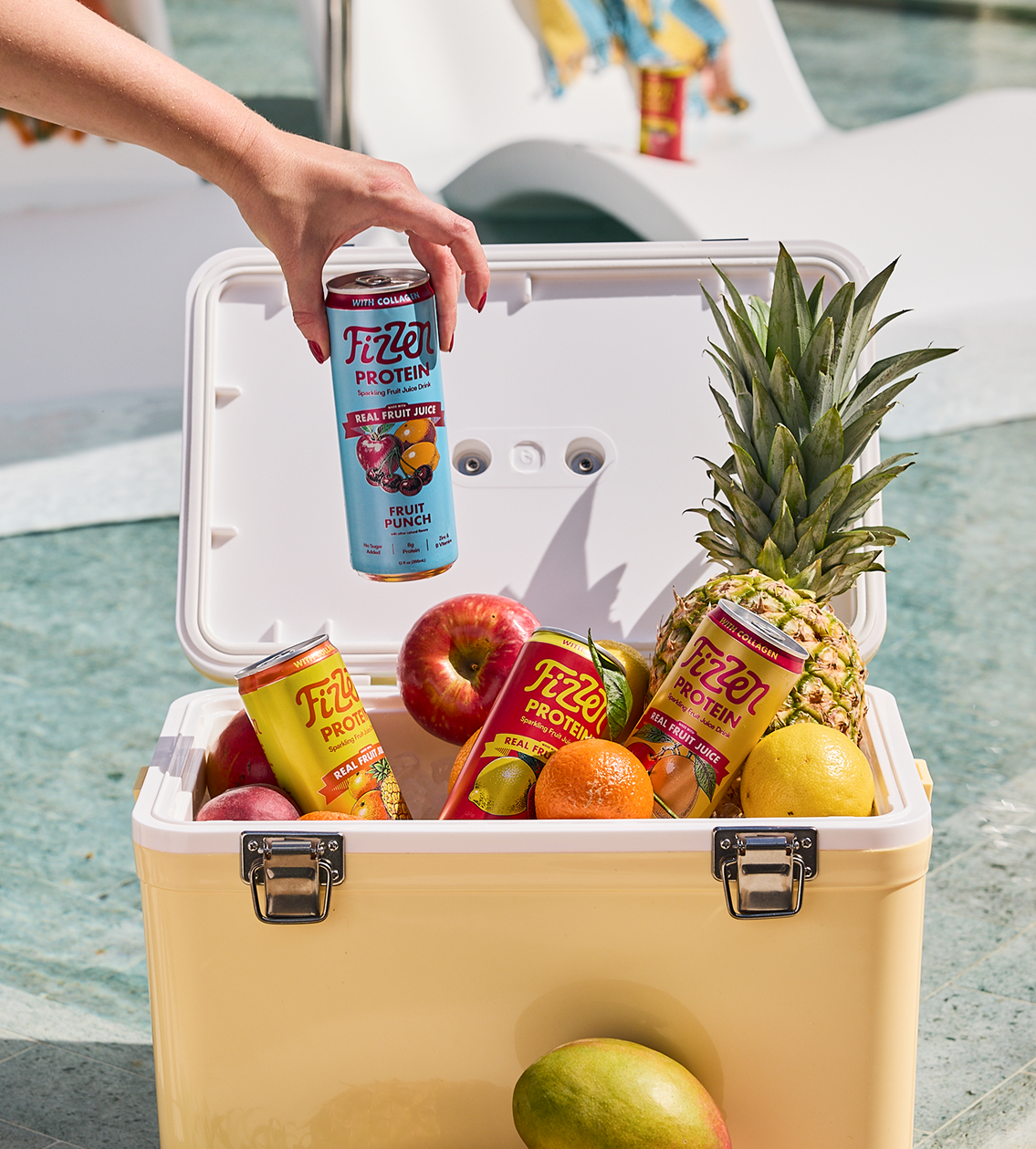 Fizzen cans in a poolside cooler with fresh fruit